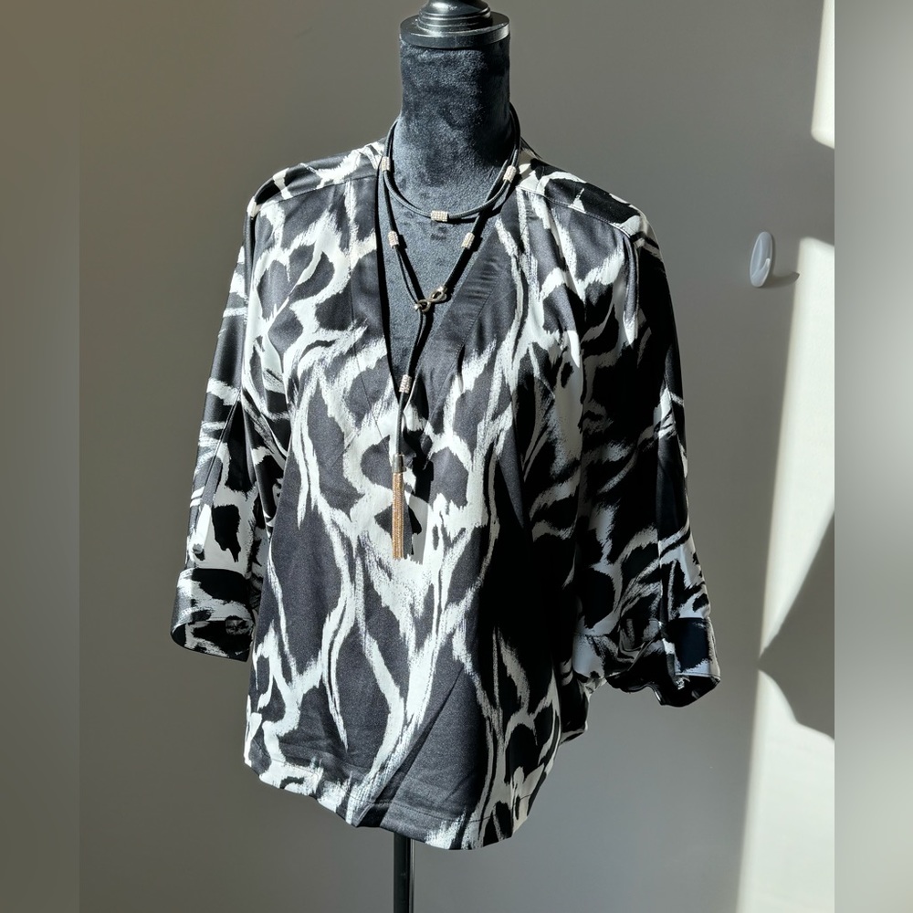 Like new WHBM black & white satin like blouse. Size L